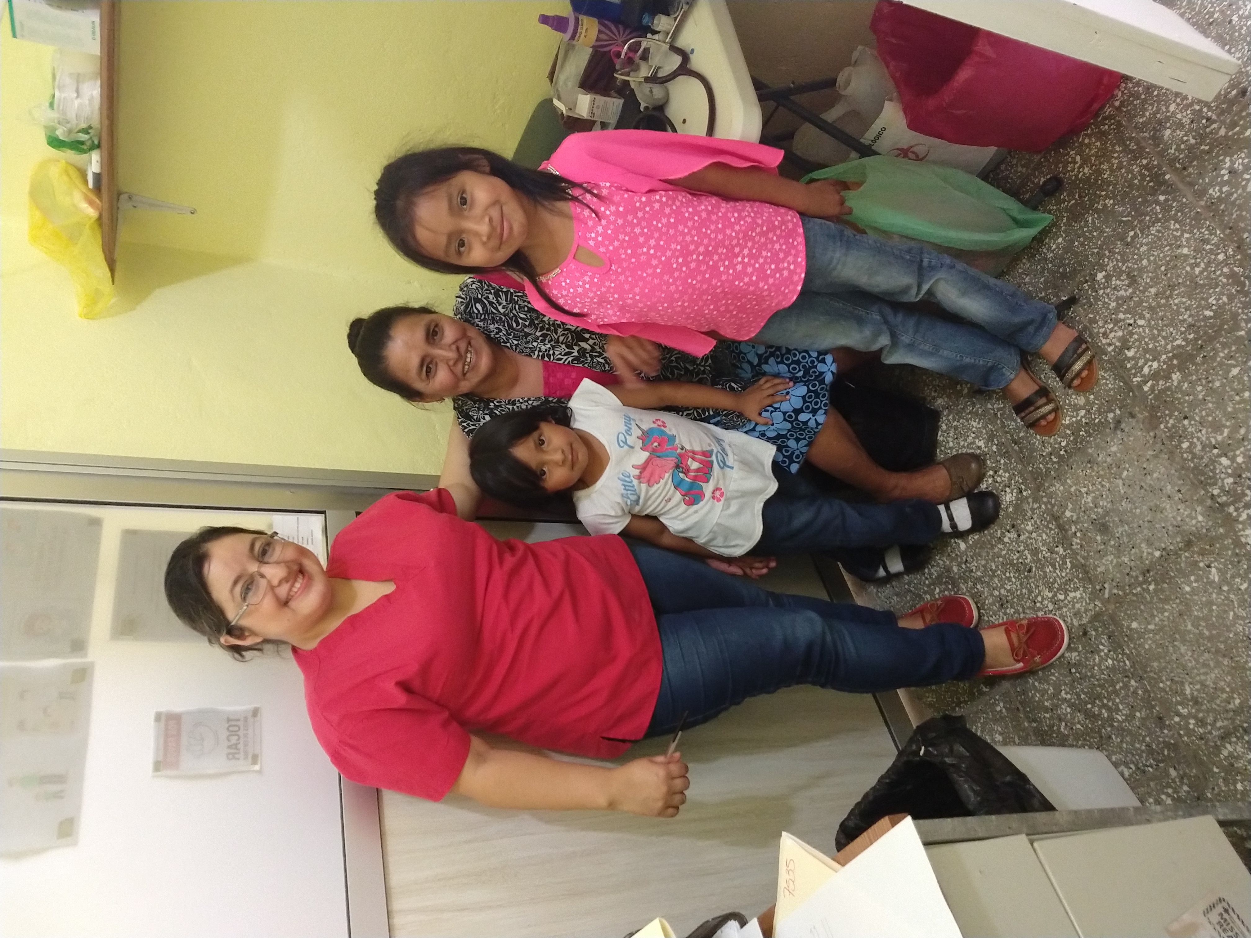 Nurse Yesenia with family in clinic